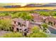 Stunning aerial view of luxury homes with beautiful desert landscaping and mountain views at sunset at 7751 E Golden Eagle Cir, Gold Canyon, AZ 85118