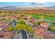 A stunning aerial view of the community homes and a golf course nestled against a picturesque mountain range at 7751 E Golden Eagle Cir, Gold Canyon, AZ 85118