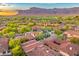 Expansive aerial view of an upscale neighborhood with lush greenery, golf course and stunning mountain backdrop at 7751 E Golden Eagle Cir, Gold Canyon, AZ 85118