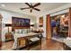 Comfortable bedroom featuring dark wood floors and a ceiling fan, plus access to an outdoor dining area at 7751 E Golden Eagle Cir, Gold Canyon, AZ 85118