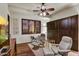 Comfortable bedroom with ceiling fan, shuttered windows, and a hideaway Murphy bed at 7751 E Golden Eagle Cir, Gold Canyon, AZ 85118