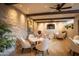 Inviting common area features stone accent wall, beamed ceiling, stylish tables and cozy seating at 7751 E Golden Eagle Cir, Gold Canyon, AZ 85118