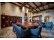 Elegant dining room boasts a grand table, fireplace, beamed ceiling, and stylish seating at 7751 E Golden Eagle Cir, Gold Canyon, AZ 85118