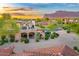 Charming home with stone accents, a private balcony, well manicured landscaping and mountain views at sunset at 7751 E Golden Eagle Cir, Gold Canyon, AZ 85118