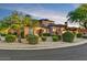 Attractive home featuring lush landscaping, stone accents, a tiled roof and a well maintained circular driveway at 7751 E Golden Eagle Cir, Gold Canyon, AZ 85118