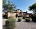 Attractive home featuring stone accents, desert landscaping, and an attached garage at 7751 E Golden Eagle Cir, Gold Canyon, AZ 85118