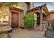 Charming entryway with stone columns, a wooden door, covered seating area and decorative water fountain at 7751 E Golden Eagle Cir, Gold Canyon, AZ 85118