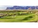 Expansive golf course with multiple sand traps and a backdrop of majestic mountains at 7751 E Golden Eagle Cir, Gold Canyon, AZ 85118