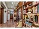 Inviting hallway featuring built-in bookshelves, hardwood floors, and stylish decor at 7751 E Golden Eagle Cir, Gold Canyon, AZ 85118