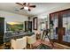 Home office with decorative ceiling fan and large workspace, plus access to a private patio at 7751 E Golden Eagle Cir, Gold Canyon, AZ 85118