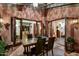 Covered outdoor dining area with a stone floor and a charming rustic ambiance at 7751 E Golden Eagle Cir, Gold Canyon, AZ 85118