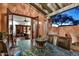 Inviting outdoor patio with marble table and chairs, and view into the interior of the home at 7751 E Golden Eagle Cir, Gold Canyon, AZ 85118