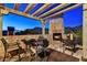 Inviting outdoor patio with stone fireplace, mountain views, pergola, and wrought iron furniture, perfect for relaxation at 7751 E Golden Eagle Cir, Gold Canyon, AZ 85118