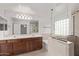 Bright bathroom featuring double sinks, bathtub, tiled shower, and frameless glass at 7812 S 67Th Ln, Laveen, AZ 85339