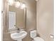 This half bathroom offers a pedestal sink, framed mirror, and classic finishes at 7812 S 67Th Ln, Laveen, AZ 85339