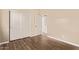 This bedroom features wood-look floors and ample closet space with sliding doors at 7812 S 67Th Ln, Laveen, AZ 85339