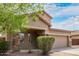 Charming two-story home featuring a well-manicured lawn, desert landscaping, and an attached two-car garage at 7812 S 67Th Ln, Laveen, AZ 85339