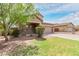 Charming two-story home featuring a well-manicured lawn, desert landscaping, and an attached two-car garage at 7812 S 67Th Ln, Laveen, AZ 85339