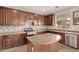 Well-appointed kitchen with custom cabinetry, granite countertops, stainless steel appliances, and tiled backsplash at 7812 S 67Th Ln, Laveen, AZ 85339
