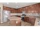 Well-equipped kitchen with stainless steel appliances, dark wood cabinetry, and center island at 7812 S 67Th Ln, Laveen, AZ 85339
