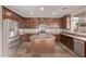 Spacious kitchen featuring wood cabinets, granite counters, stainless appliances, and center island at 7812 S 67Th Ln, Laveen, AZ 85339