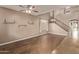 Bright and airy living room featuring soaring ceilings, hardwood floors, and a staircase to the second level at 7812 S 67Th Ln, Laveen, AZ 85339