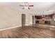 Open-concept living room flowing into a kitchen with hardwood floors and natural lighting at 7812 S 67Th Ln, Laveen, AZ 85339