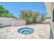 Private backyard featuring a hot tub, desert landscaping, and tiled patio, perfect for outdoor relaxation and entertaining at 8525 E Vía De Los Libros --, Scottsdale, AZ 85258
