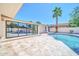 Backyard features a pristine pool, a covered patio area, and modern landscaping with tall palm trees at 8525 E Vía De Los Libros --, Scottsdale, AZ 85258