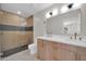 A renovated bathroom with tiled shower, double vanity, and modern fixtures at 8525 E Vía De Los Libros --, Scottsdale, AZ 85258