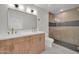 Bathroom with a double vanity with gold fixtures and a glass-enclosed shower at 8525 E Vía De Los Libros --, Scottsdale, AZ 85258