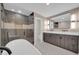 Modern bathroom with a double vanity, large mirror, and glass-enclosed shower at 8525 E Vía De Los Libros --, Scottsdale, AZ 85258