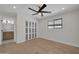 Bright bedroom featuring a ceiling fan, sliding door closet, and a view into the ensuite at 8525 E Vía De Los Libros --, Scottsdale, AZ 85258