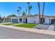 Charming single-story home featuring a modern garage door and manicured front yard at 8525 E Vía De Los Libros --, Scottsdale, AZ 85258