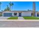 Charming single-story home featuring a modern garage door and lush green landscaping at 8525 E Vía De Los Libros --, Scottsdale, AZ 85258