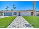 Charming single-story home with manicured front lawn and modern paved walkway at 8525 E Vía De Los Libros --, Scottsdale, AZ 85258