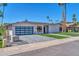 Charming single-story home featuring a modern garage door and beautiful landscaping at 8525 E Vía De Los Libros --, Scottsdale, AZ 85258