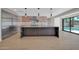 Modern kitchen with stainless steel appliances, island and light hardwood flooring at 8525 E Vía De Los Libros --, Scottsdale, AZ 85258