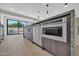 Kitchen island featuring a stainless steel microwave and dishwasher with backyard pool view at 8525 E Vía De Los Libros --, Scottsdale, AZ 85258