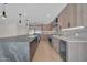 Open kitchen featuring stainless steel appliances, a large island with a sink, and modern light fixtures at 8525 E Vía De Los Libros --, Scottsdale, AZ 85258