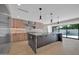 Bright kitchen with a large island, stainless steel appliances, and sliding glass doors to the backyard pool at 8525 E Vía De Los Libros --, Scottsdale, AZ 85258
