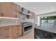 Modern kitchen with stainless steel range and light wood cabinets with under cabinet lighting at 8525 E Vía De Los Libros --, Scottsdale, AZ 85258