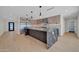 Spacious kitchen with large center island, stainless steel appliances, and light wood floors at 8525 E Vía De Los Libros --, Scottsdale, AZ 85258