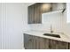 Stylish laundry room features sleek cabinetry, modern fixtures, and attractive patterned wallpaper at 8525 E Vía De Los Libros --, Scottsdale, AZ 85258