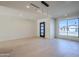 Bright living room featuring hardwood floors, modern lighting fixtures, and a large window that provides natural light and views at 8525 E Vía De Los Libros --, Scottsdale, AZ 85258