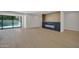 Bright living room boasts modern fireplace, sliding glass doors and light hardwood floors at 8525 E Vía De Los Libros --, Scottsdale, AZ 85258