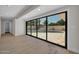 Bright living room featuring glass doors with an outdoor view of a swimming pool and patio at 8525 E Vía De Los Libros --, Scottsdale, AZ 85258