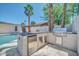 Outdoor kitchen with built-in grill, sink, beverage cooler next to a refreshing pool for entertaining at 8525 E Vía De Los Libros --, Scottsdale, AZ 85258