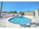 Inviting backyard pool with a travertine deck, outdoor kitchen area, and lush, mature landscaping at 8525 E Vía De Los Libros --, Scottsdale, AZ 85258