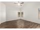 This bedroom is bright, featuring wood floors and multiple windows to let in natural light at 8648 W Fargo Dr, Peoria, AZ 85382
